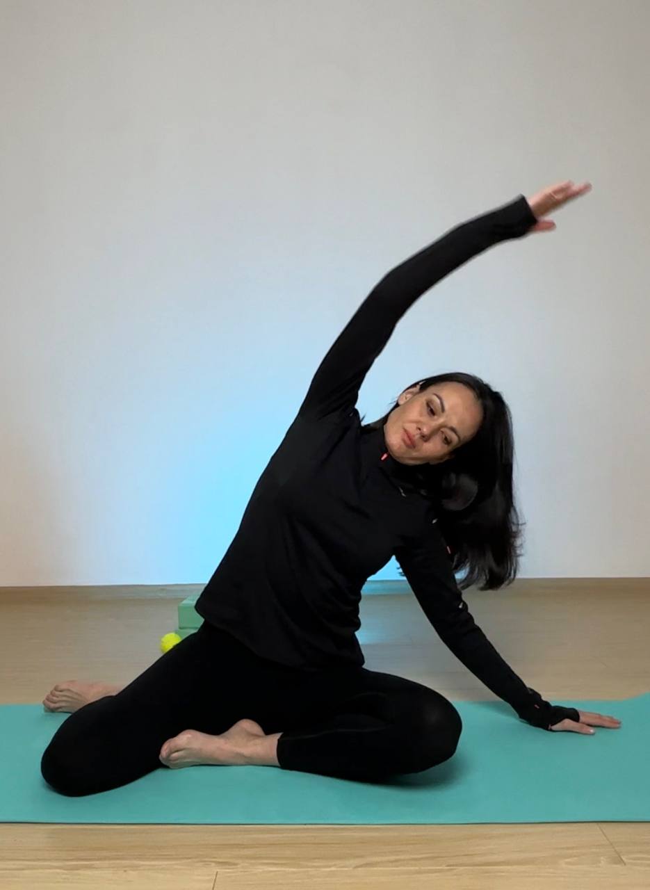 Marina demonstrating a body and posture exercise
